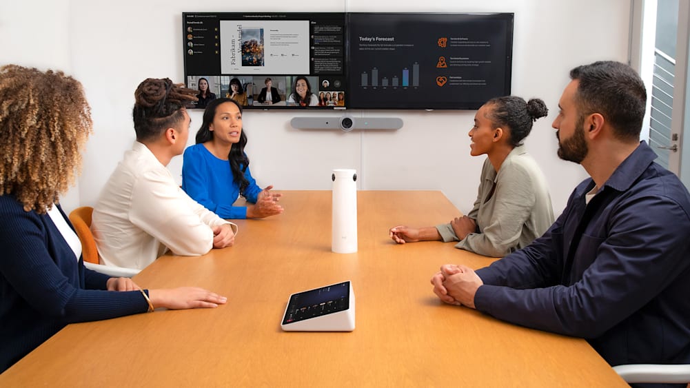 Five people in a meeting room on a video call equipped with Sight AI camera