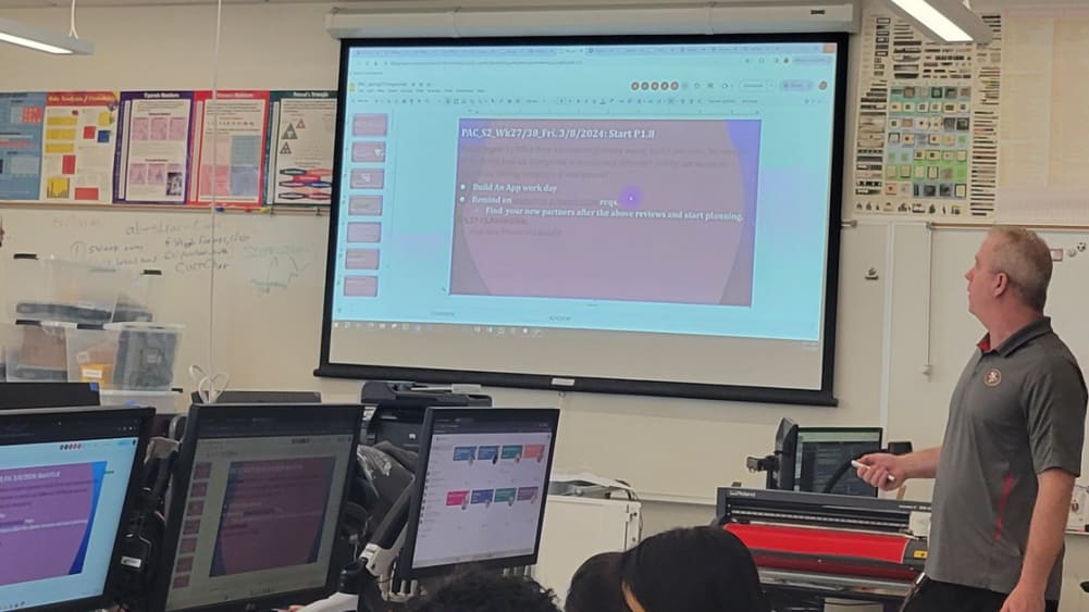 Teacher using a presentation remote for teaching
