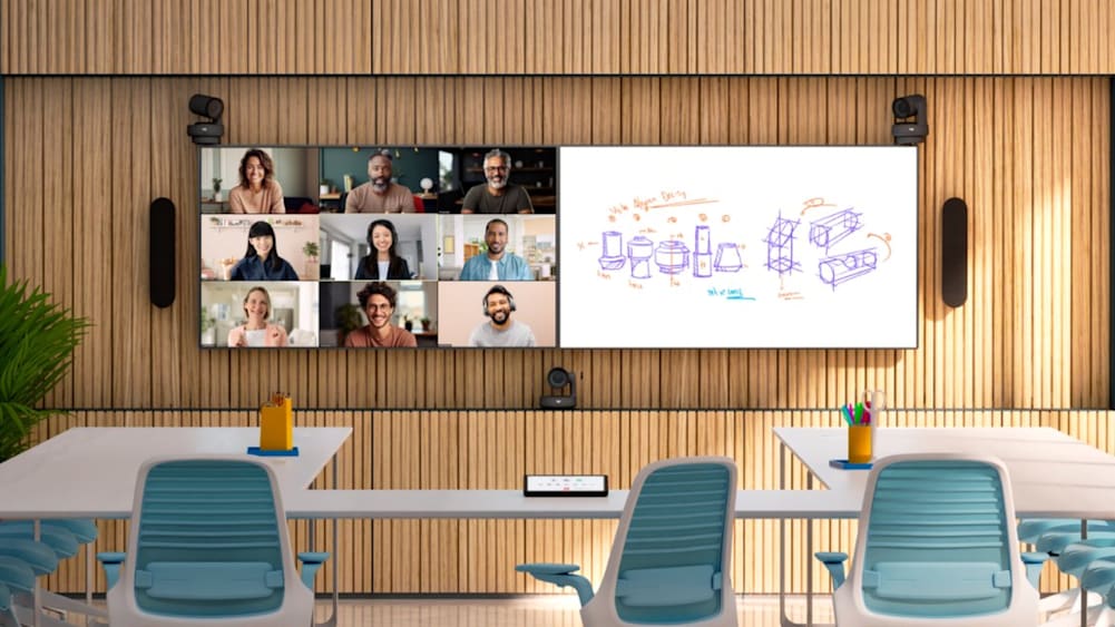 A Logitech-equipped meeting room with a large screen displaying a video conference with multiple participants and a digital whiteboard