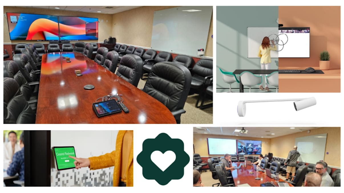 Conference room with long wooden table, leather chairs, dual display screens, and Logitech video conferencing setup.