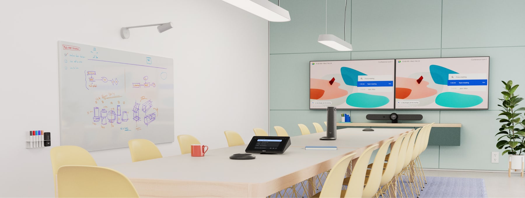 Boardroom with long table, yellow chairs, dual displays, Logitech Rally Bar, Tap, Mic Pods, and Scribe camera on the wall.