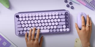 Hands typing on keyboard and holding a mouse