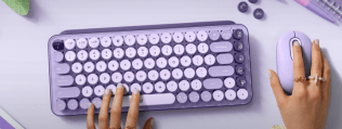 Hands typing on keyboard and holding a mouse