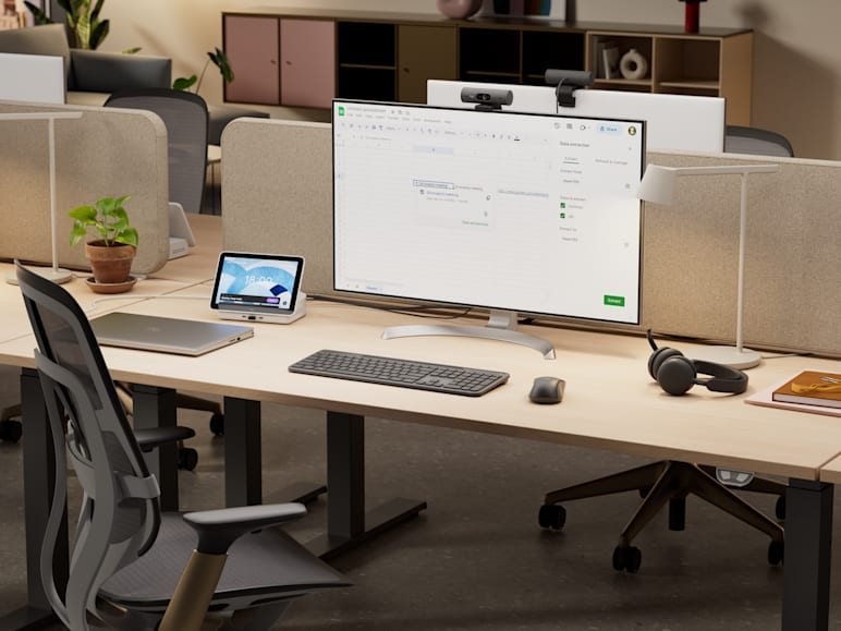 A flex desk is outfitted with Logitech peripherals ideal for flexible workflows.