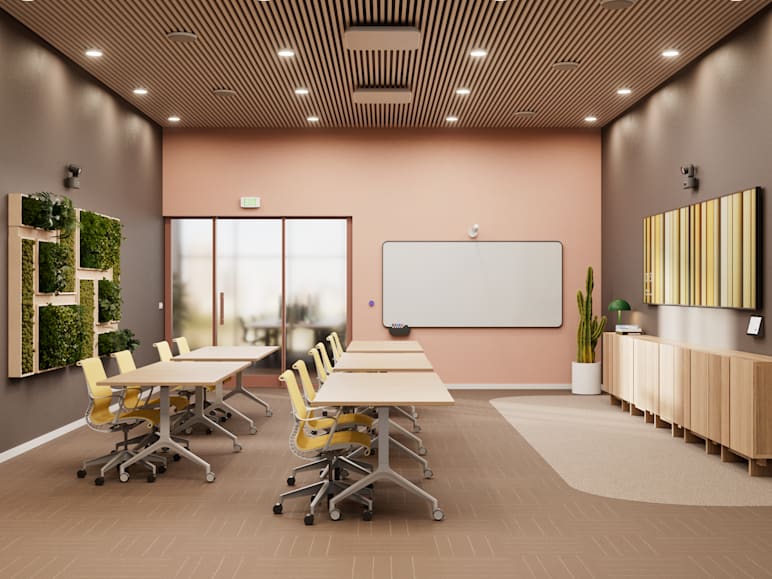 A large training space with two Rally AI Camera Pro video conferencing cameras; one positioned in the front of the room, one in the back.