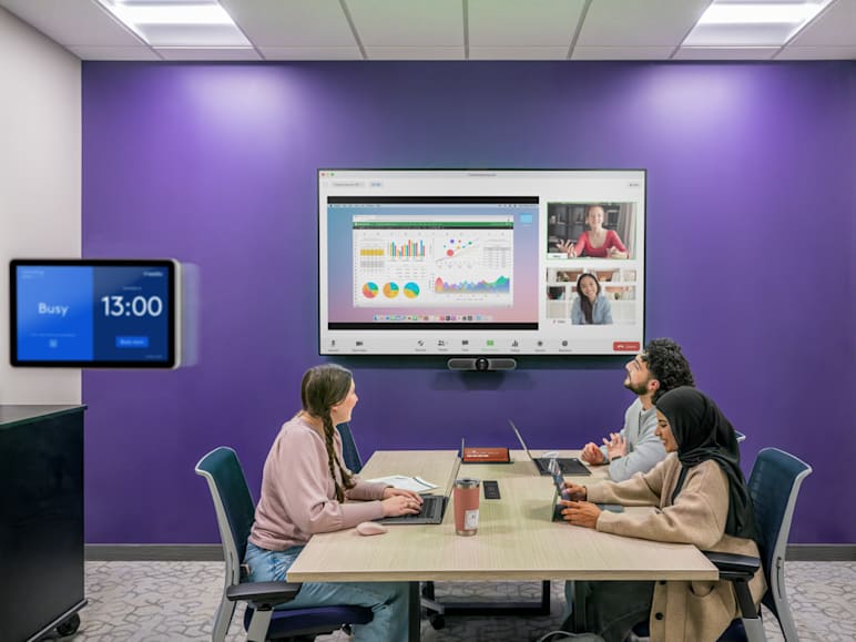  Students using Logitech AV technology for video conferencing and collaborative learning in a modern university classroom.