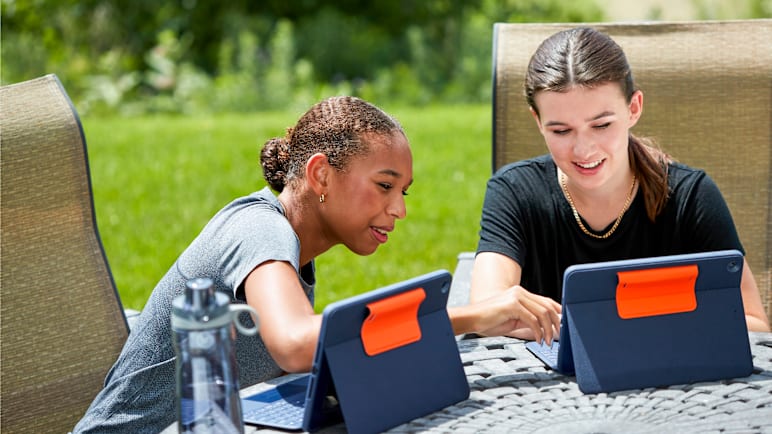 Girls outdoors using their tablets