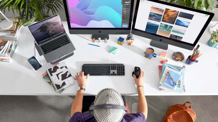 Man using Logitech products in front of a Mac computer