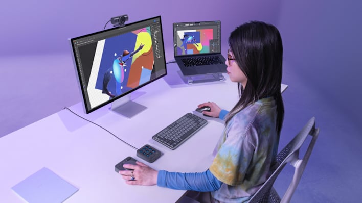 Person using MX Creative Console to edit video